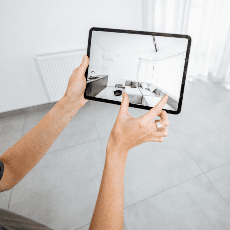 Augmented reality is helping ecommerce. Image portrays a user using augmented reality to view how a couch may look in their space by using AR on their ipad